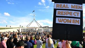 Crowds in Canberra marched to Parliament House to call for action to end violence against women. (Lukas Coch/AAP PHOTOS)