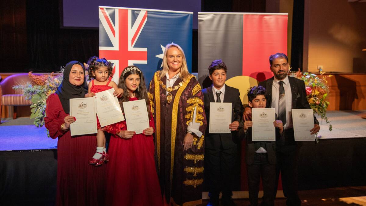 Kanirosh Tahir (left), City of Newcastle lord mayor Nuatali Nelmes (centre), Azad Ramo (right) with their family. Picture supplied 