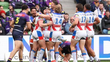 Knights players rally around Fletcher Sharpe after the fullback's maiden try. Picture Getty Images 